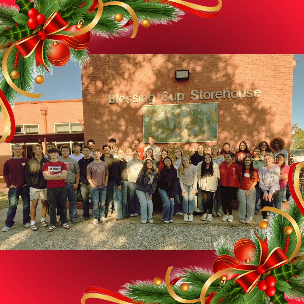 group of kids by the blessing cup sign