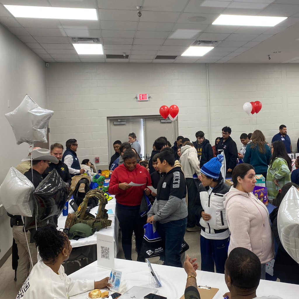 students talking to vendors around a room