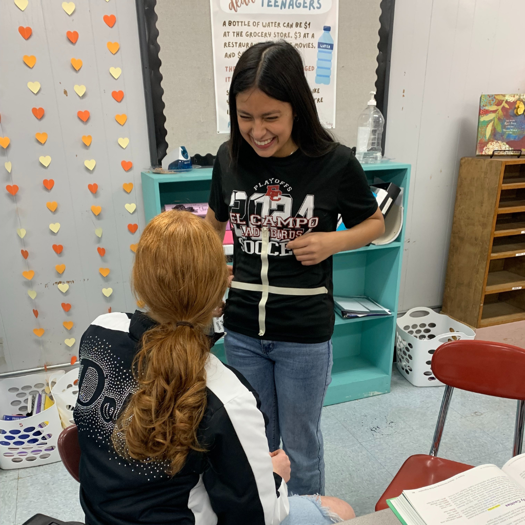 student with tape on her shirt to show the 4 quadrants of her upper body