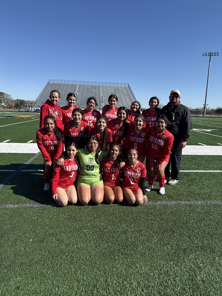 JV ladybird soccer team with coaches