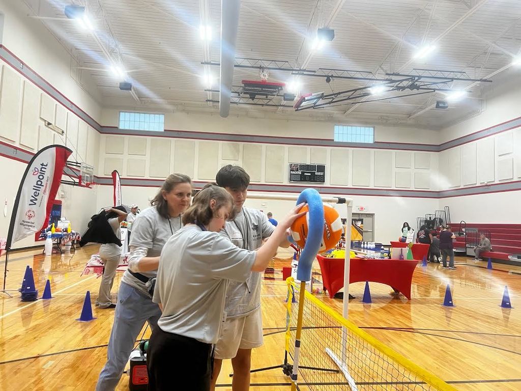 Summer putting ball through a hoop
