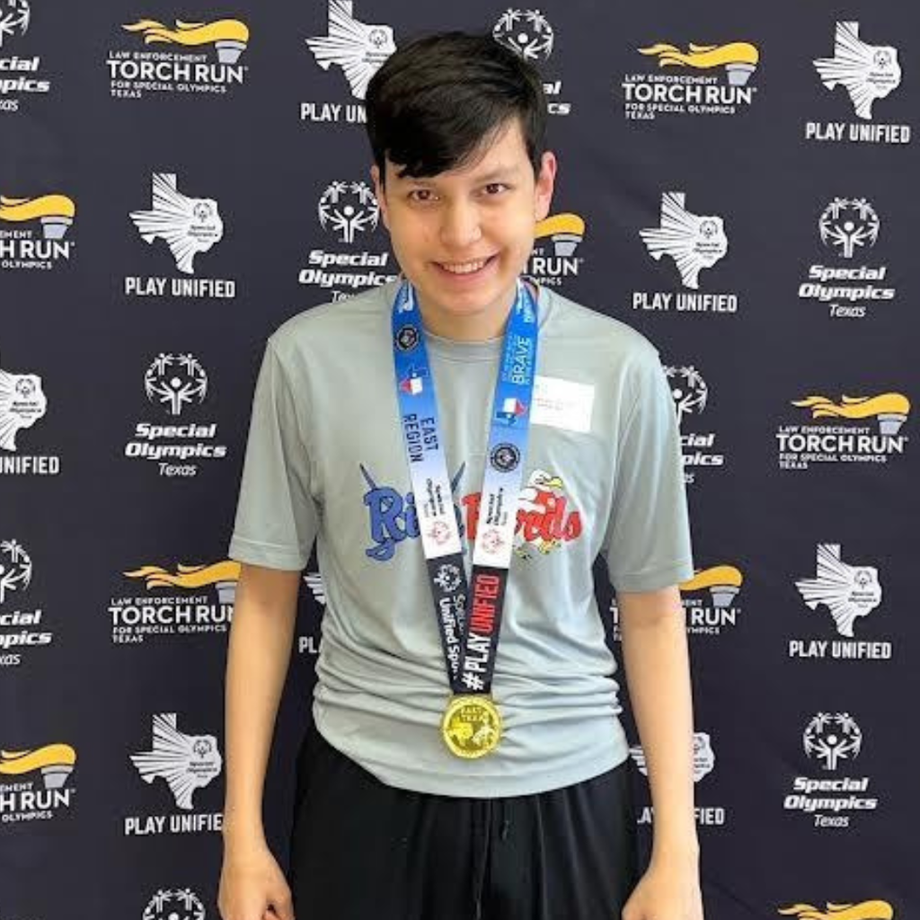 Felix Saenz wearing a gold medal