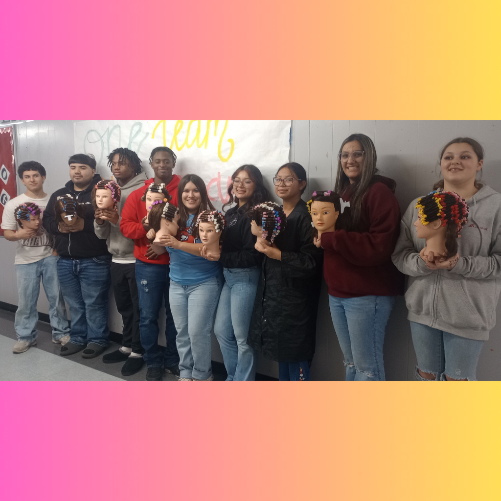 4 boys and 5 girls proudly holding a mannequin head featuring a completed permanent wave hair-rolling technique