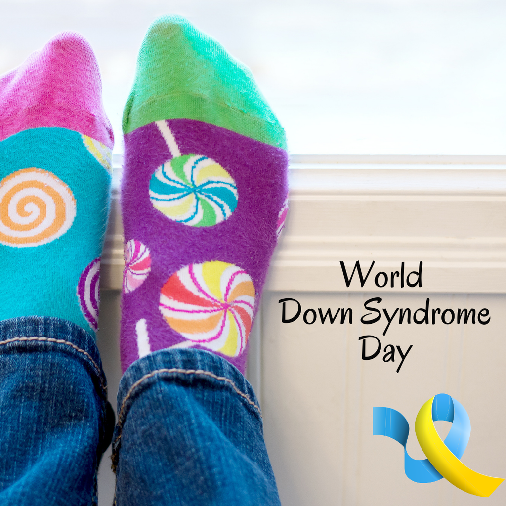 a set of feet wearing mismatched socks with the words world down syndrome day and a blue and yellow ribbon