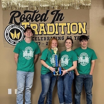 4 kids holding a trophy