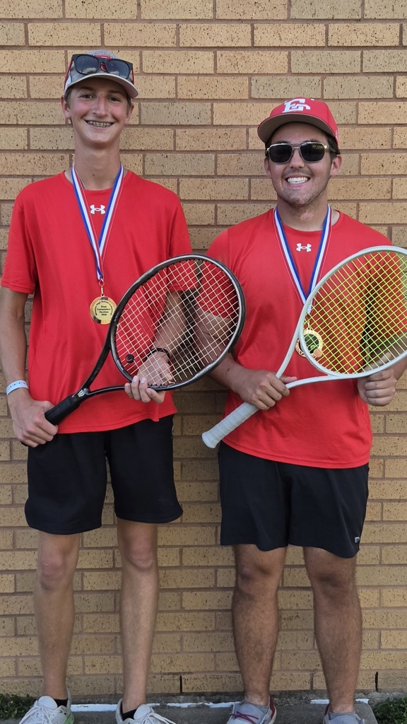 popp and conrad wearing medals and holding their rackets