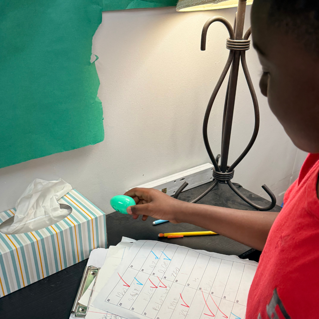A 5th-grade student discovers a green Easter egg during a classroom math review activity