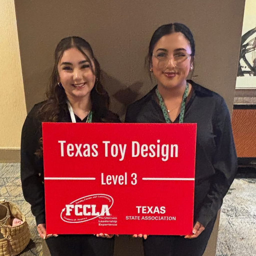 fernandez and escamilla hold a red sign that reads "Texas Toy Design Level 3" with the FCCLA Texas State Association logo.