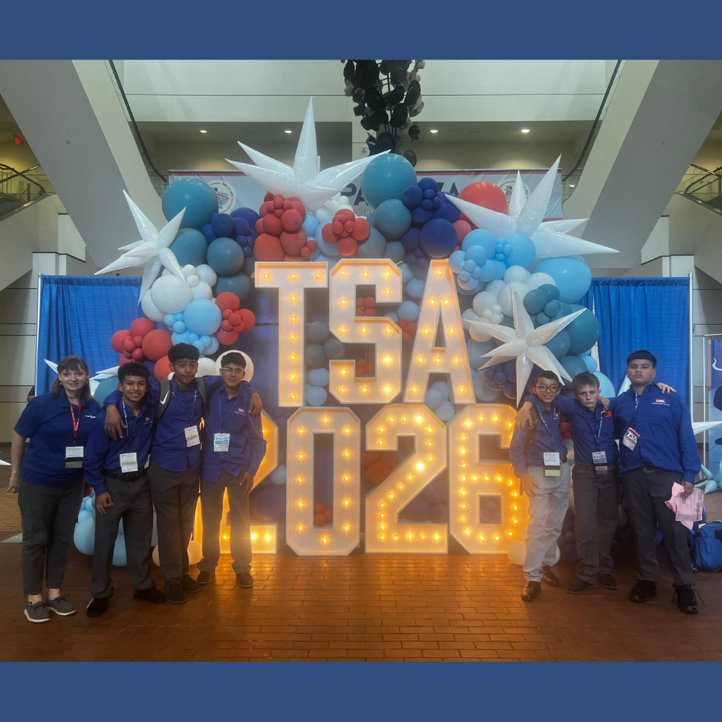 Six ECMS Technology Student Association students and sponsor standing together at the state contest, smiling by the TSA 2026 sign