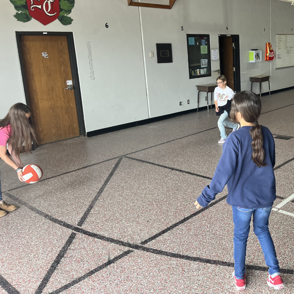 3 girls playing four square