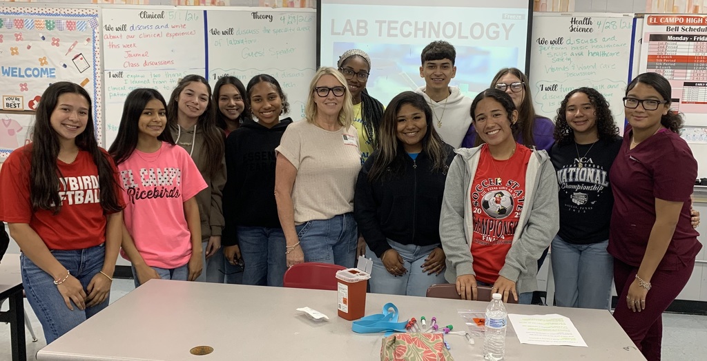 13 high school kids standing with Moller in the classroom