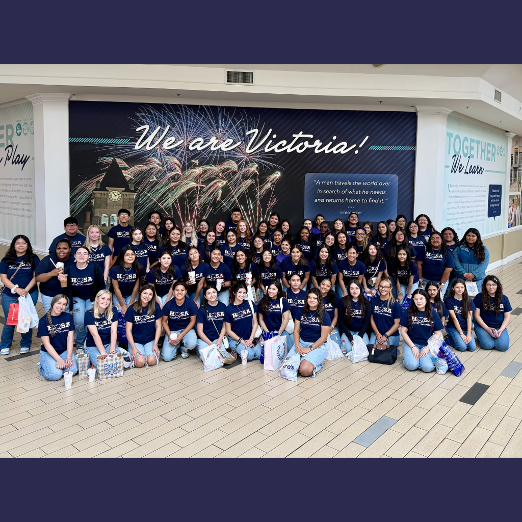 80 students pose in group picture at the mall