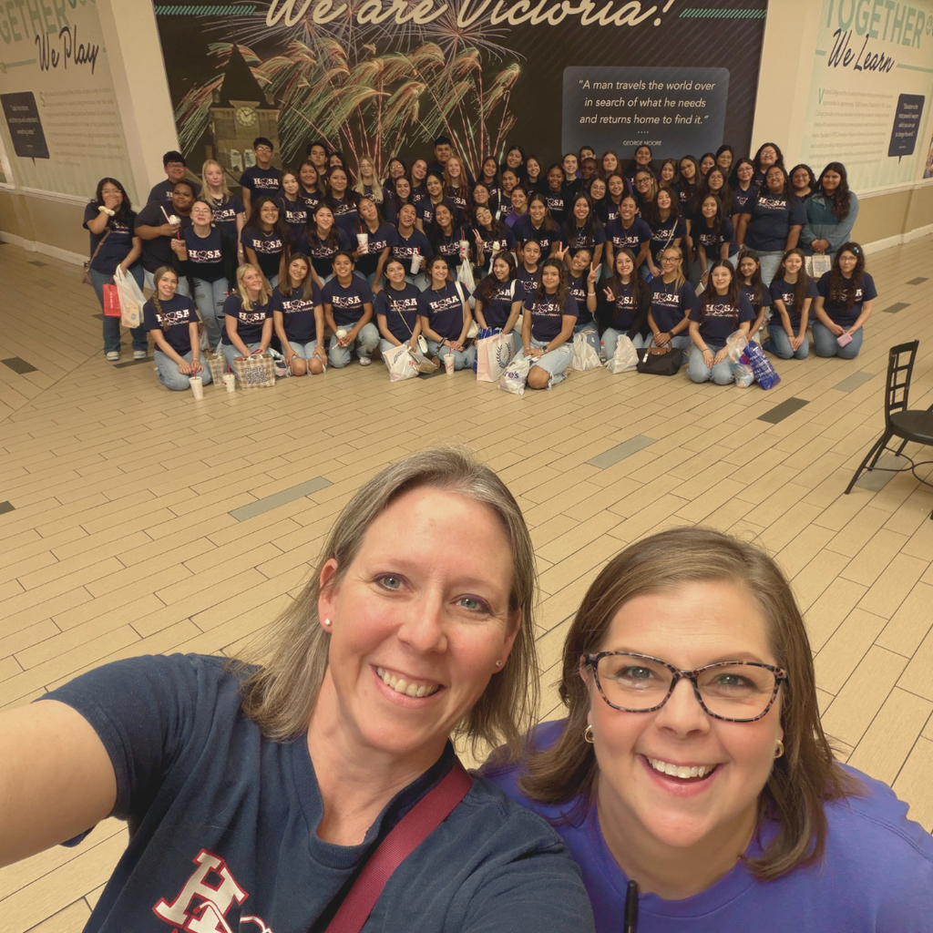 teachers taking a selfie with all off the students behind them at the mall