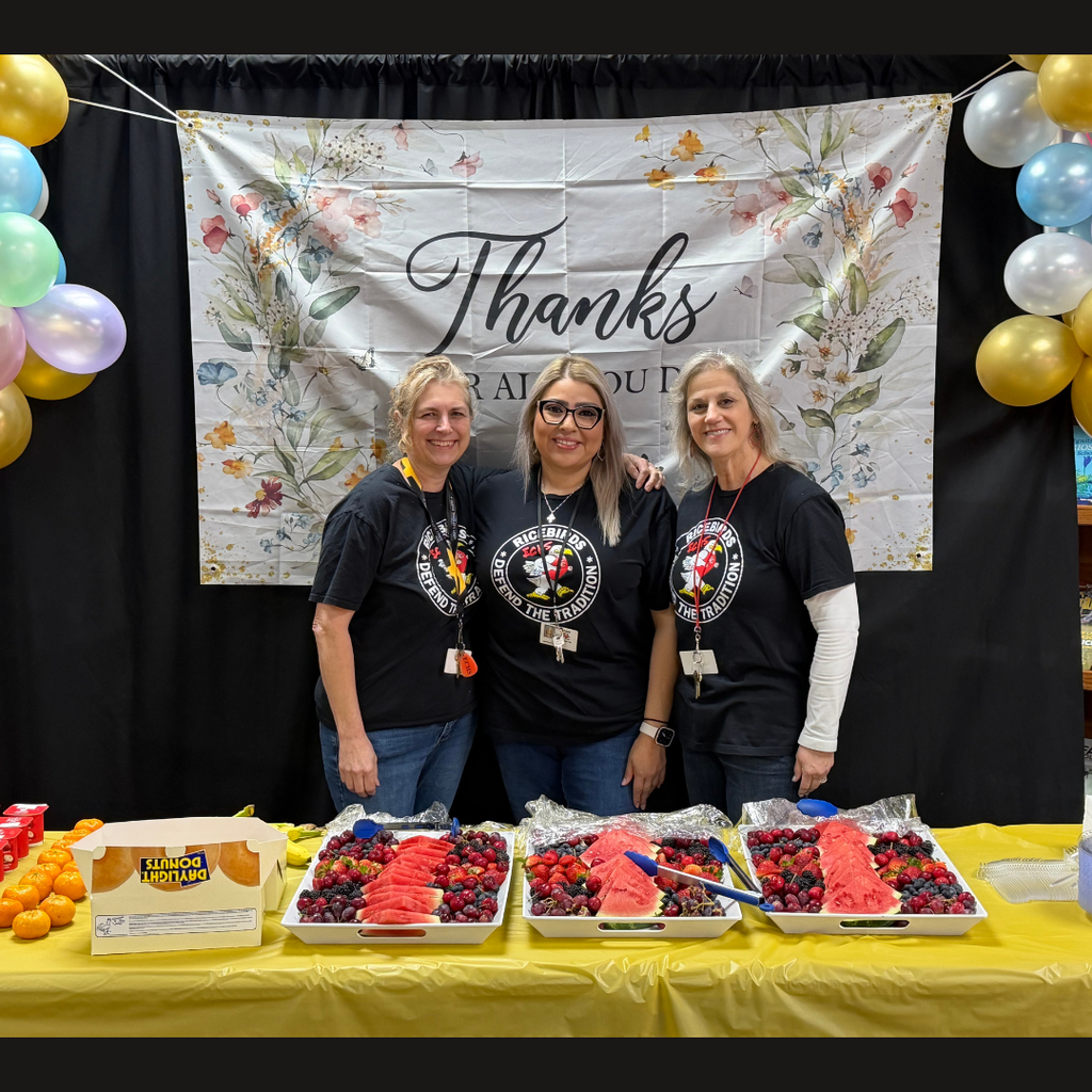 3 teachers posing by "thanks for all you do" banner