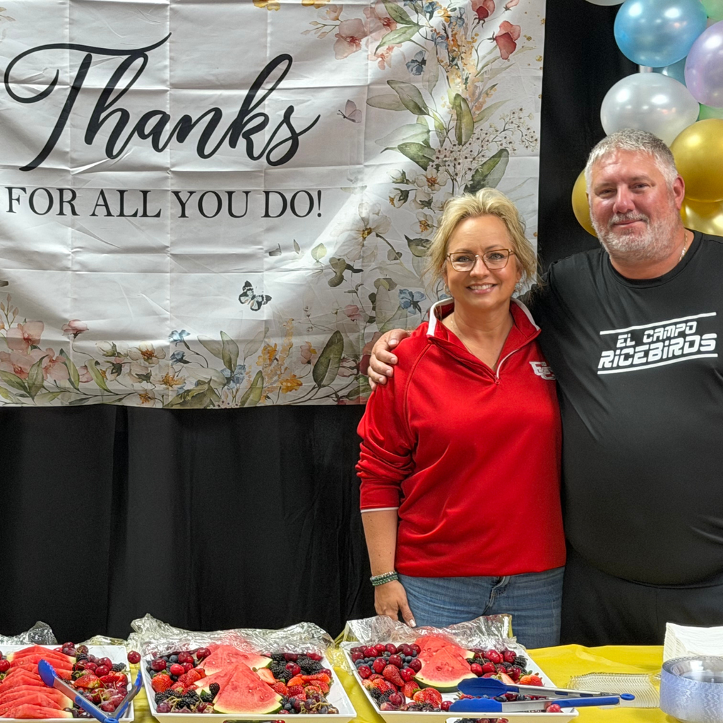 2 teacher by the "thanks for all you do banner"