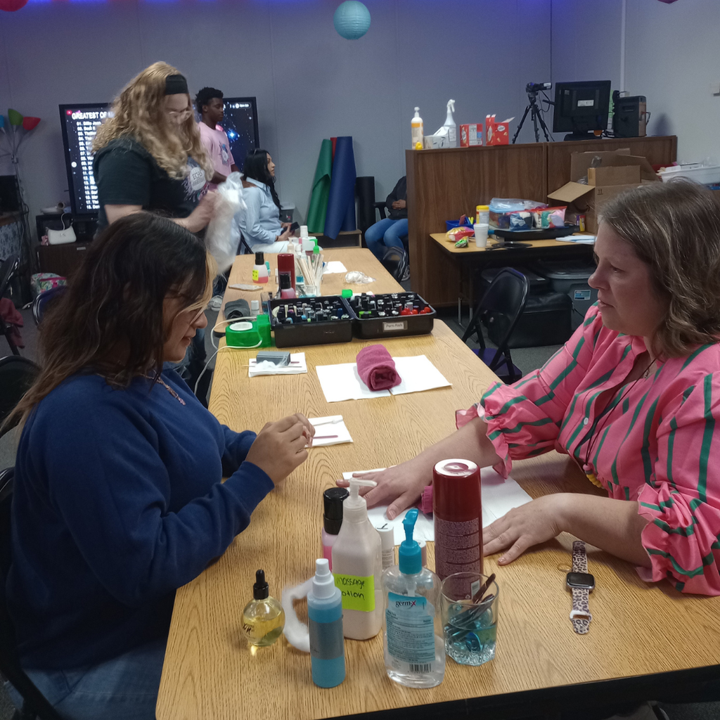 Close-up of an ECHS cosmetology student giving a mini manicure to a Myatt staff member.