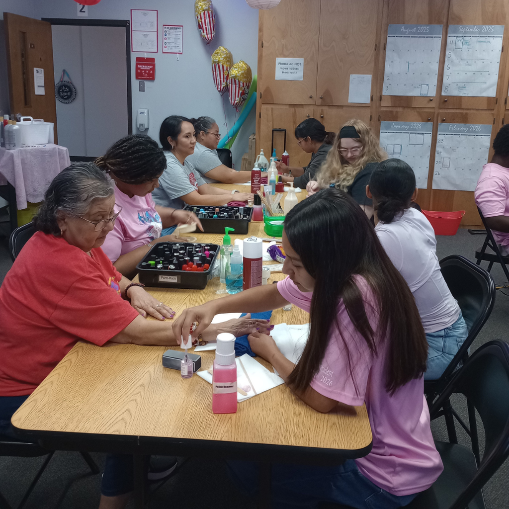 Close-up of ECHS cosmetology students giving mini manicures to Myatt staff members.