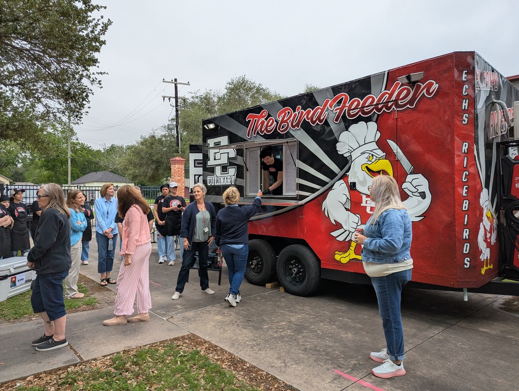 A group of El Campo ISD staff members standing in line outdoors to order from "The Bird Feeder" food truck