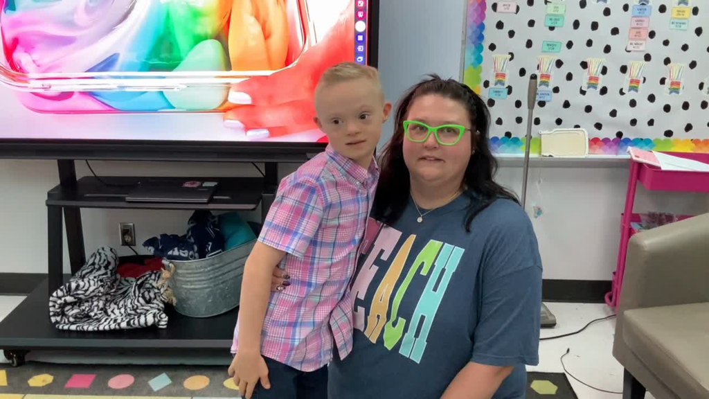 student giving a teacher a hug