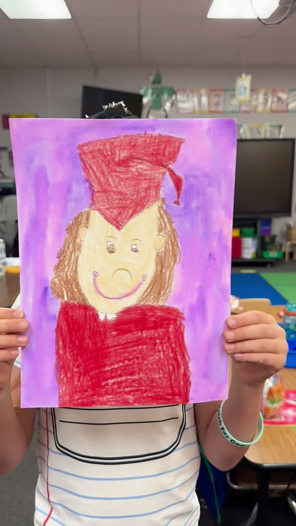 self portrait drawing of a kindergarten graduate in a red cap and gown