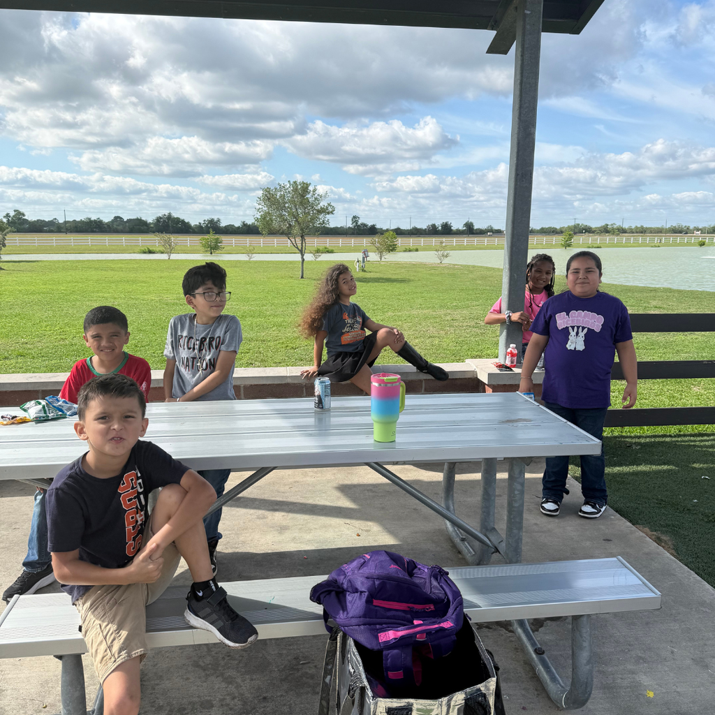 kids at a picnic table at the park by the lake