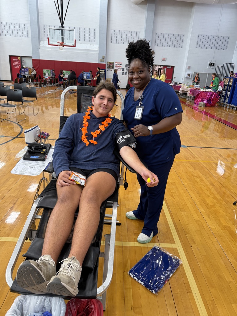 a donor with a blood drive worker