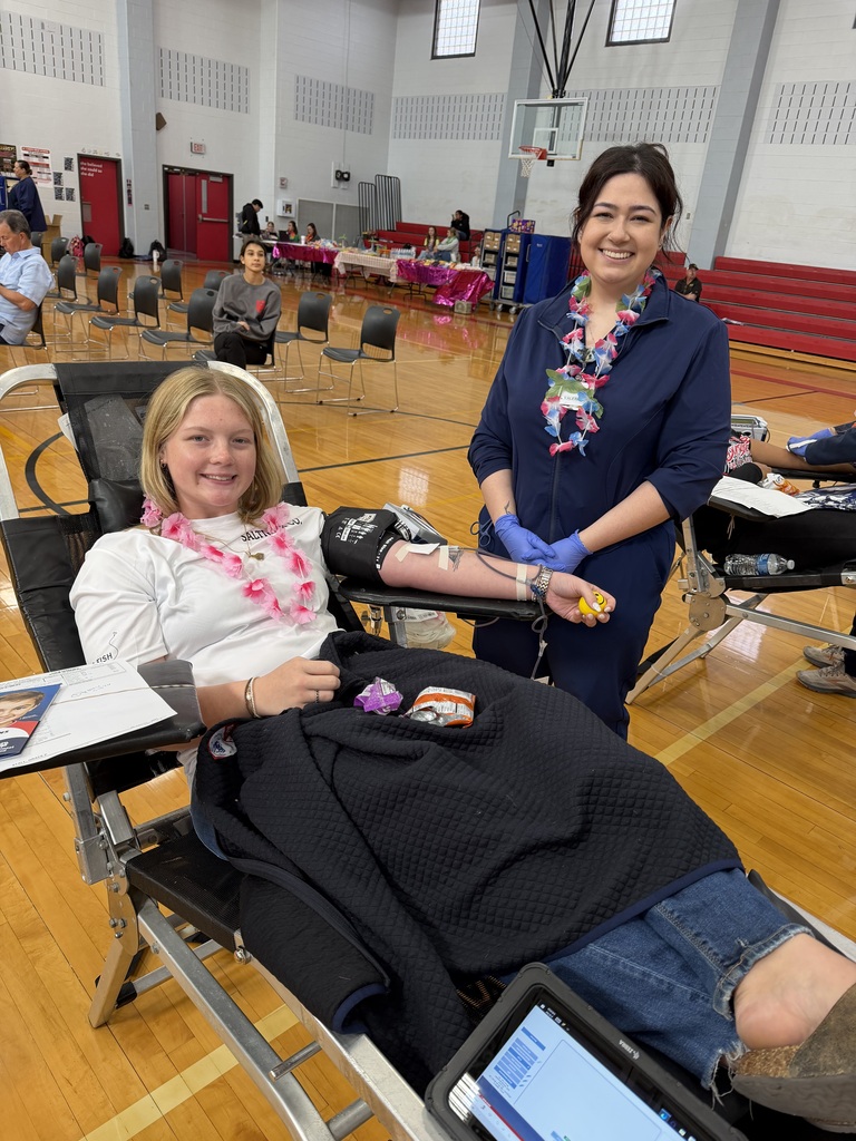 a donor with a blood drive worker