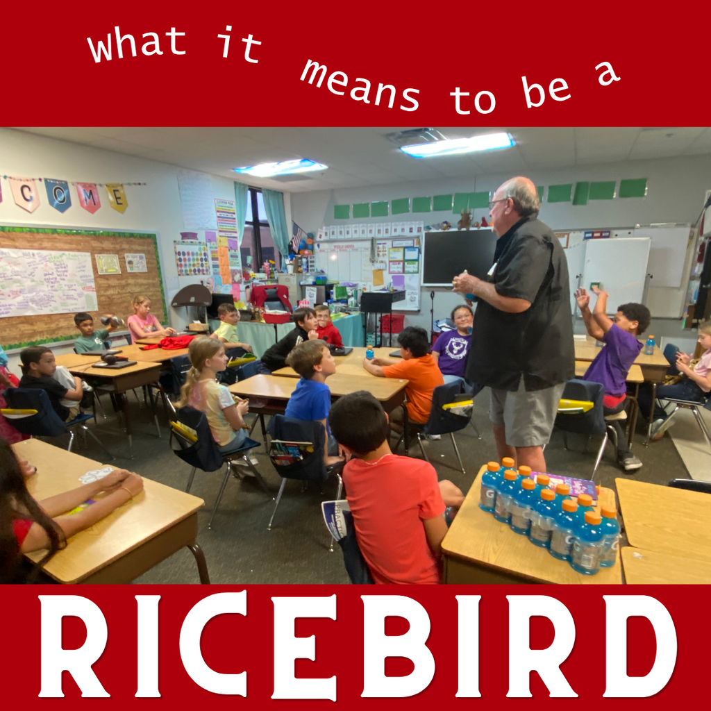 Doc Easter speaking to a classroom of young students at El Campo ISD. He is standing at the front of the room gesturing while the students sit at their desks listening. A pack of Gatorade bottles sits on a desk in the foreground. The top and bottom of the image feature a red border with the text "what it means to be a RICEBIRD".