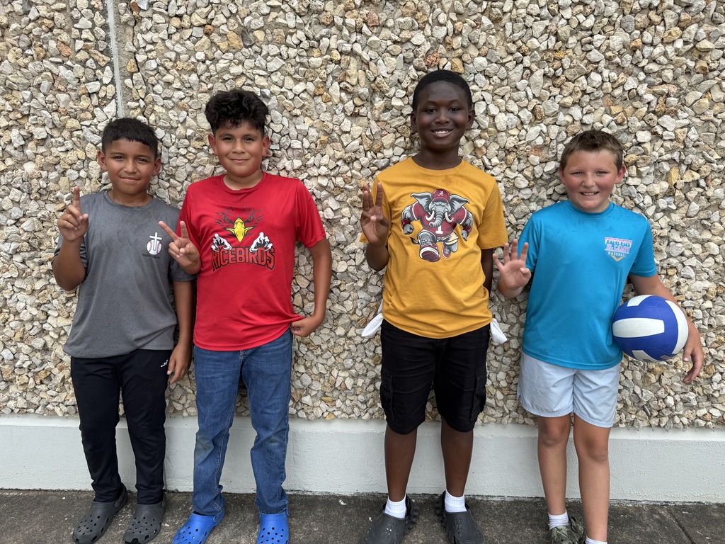 4 boys posing for "winners" picture