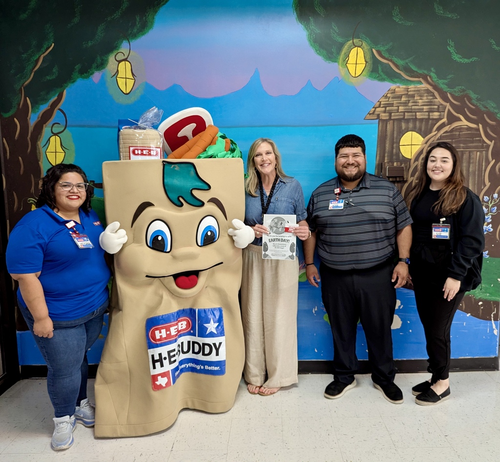Myatt Elementary assistant principal proudly holding a giant $300 H-E-B gift card reward next to the H-E-Buddy mascot and 3H-E-B employees.