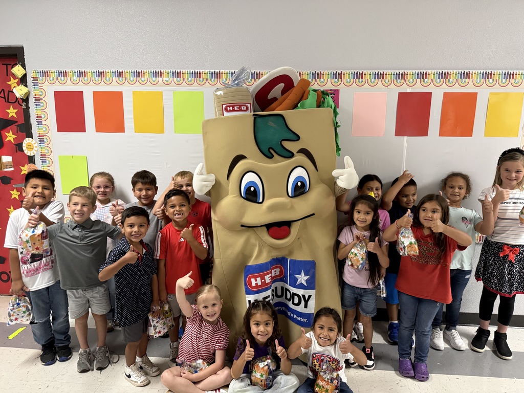 A photograph of the H-E-Buddy mascot posing with students  from Treme's class at Myatt, celebrating their Earth Day plastic bag collection win.