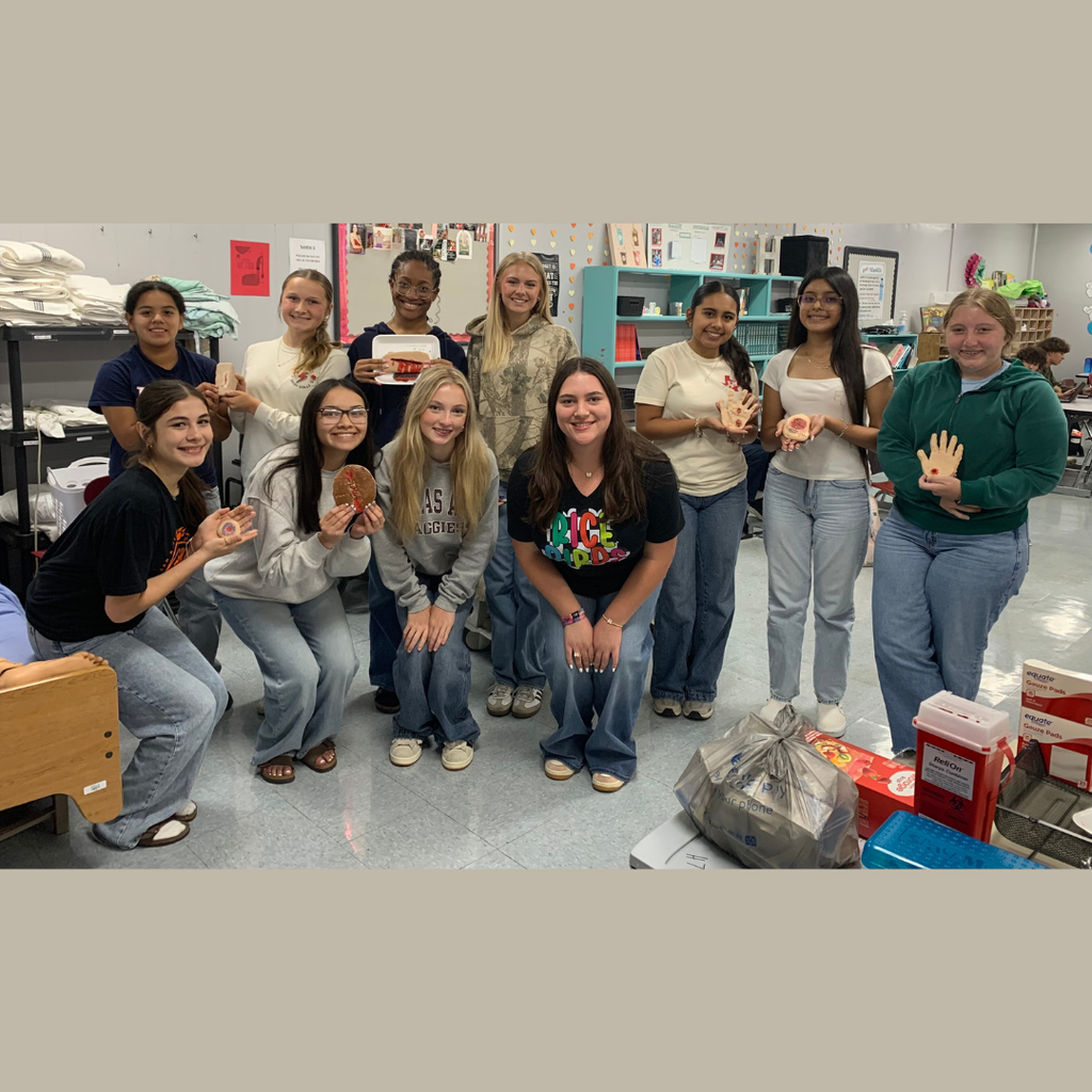 class picture of students holding their wound