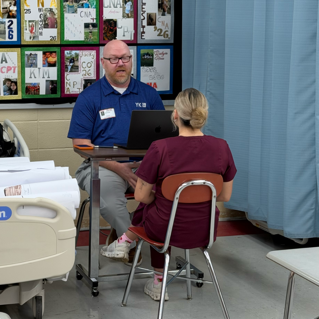 Green interviewing a student in scrubs