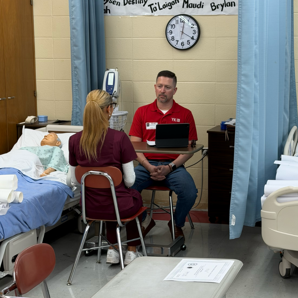Kacer interviewing a student in scrubs