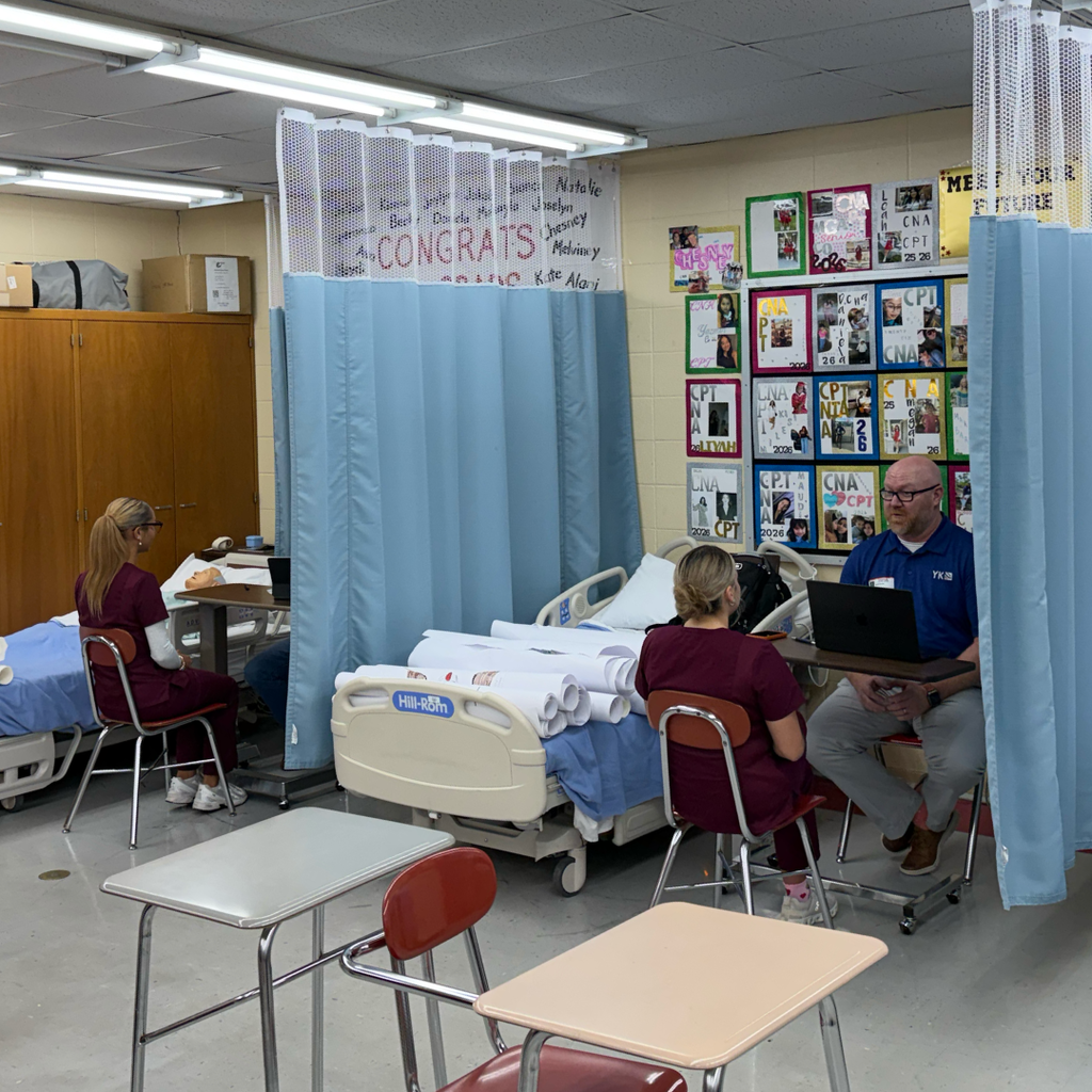 green interviewing a student in scrubs
