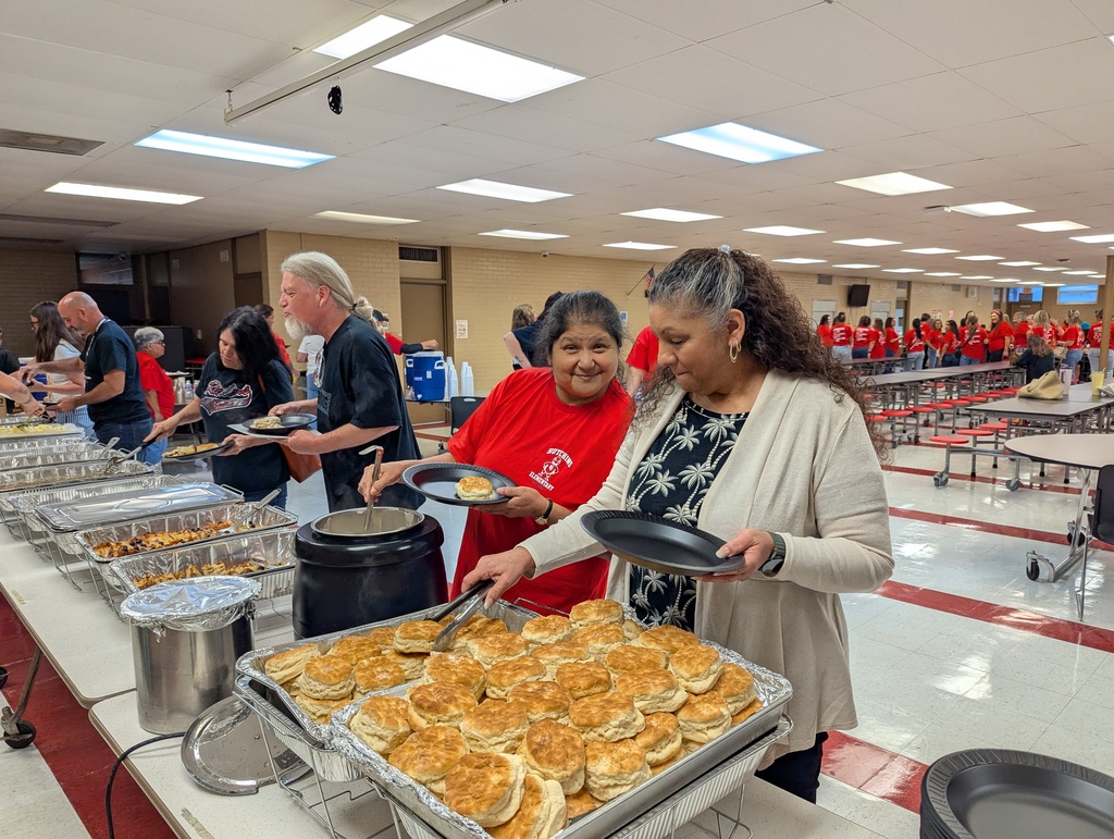 adults making plates of breakfast food