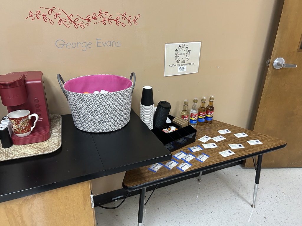 table with coffee  and flavorings to mix in 
