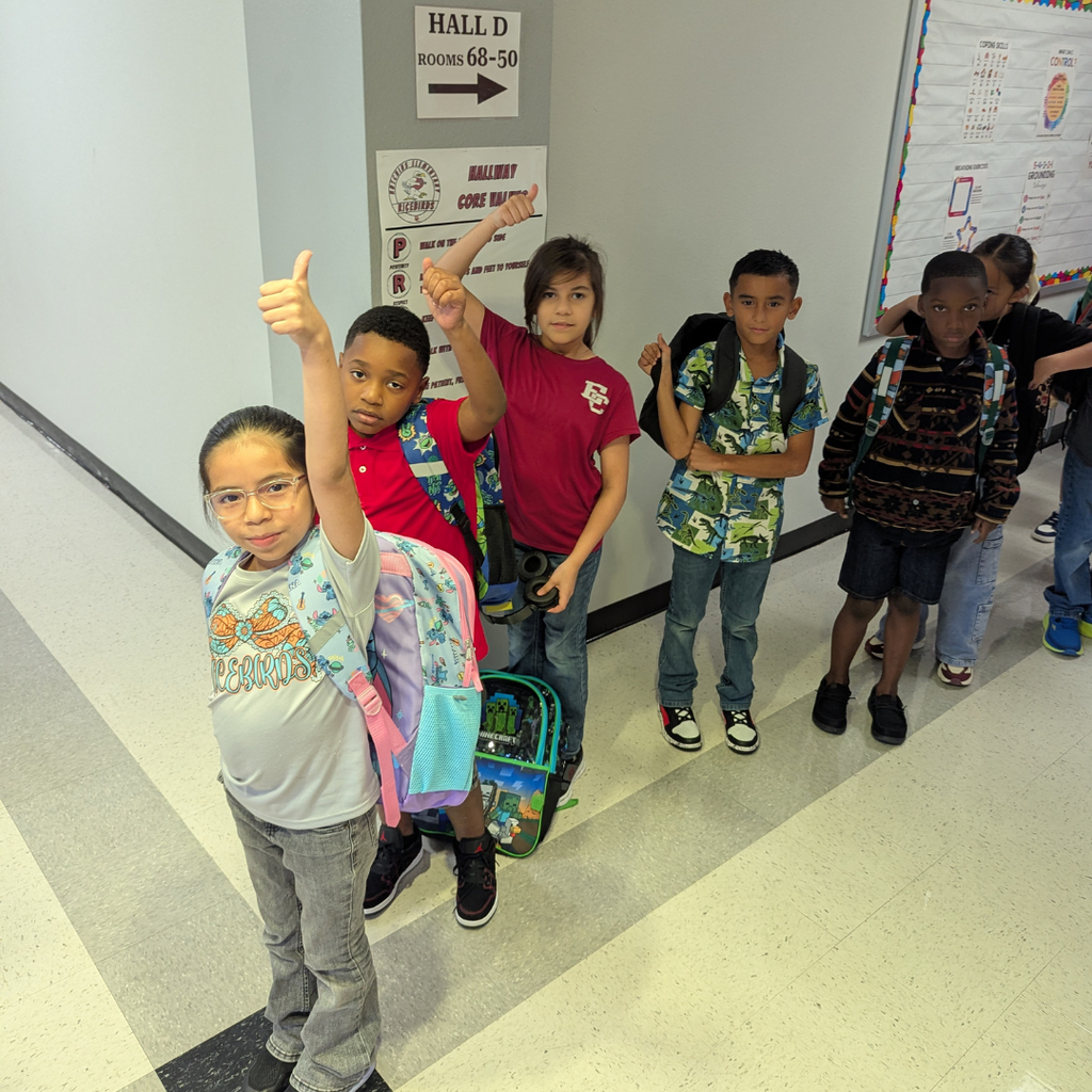 5 students giving a thumbs up