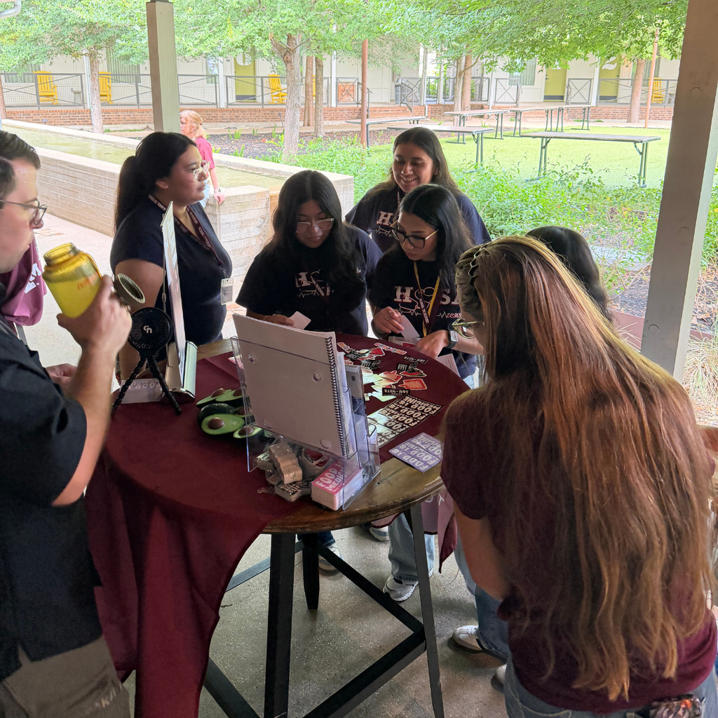 students at a vendor booth