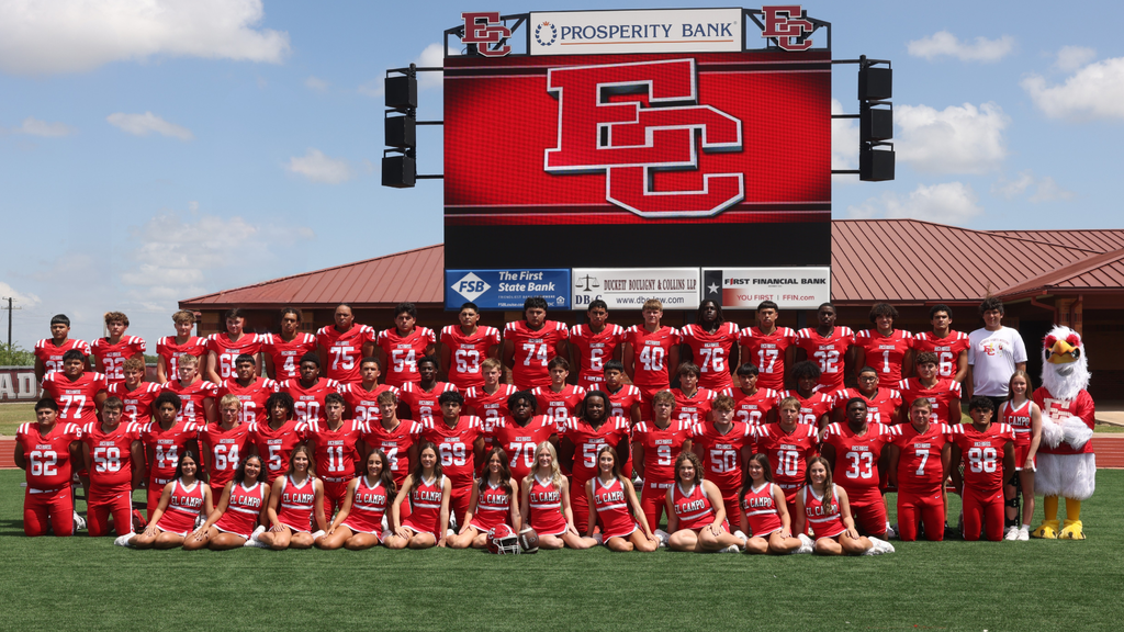 football team and cheerleaders posed for group picture