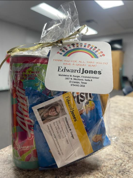 Gift bag filled with snacks and school supplies featuring an Edward Jones tag from Financial Advisor Madeleine W. Sanger, with a note reading "Thank you for all that you do! Have a great year!"