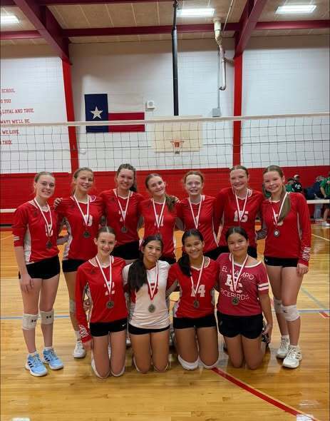 freshman volleyball team wearing medals