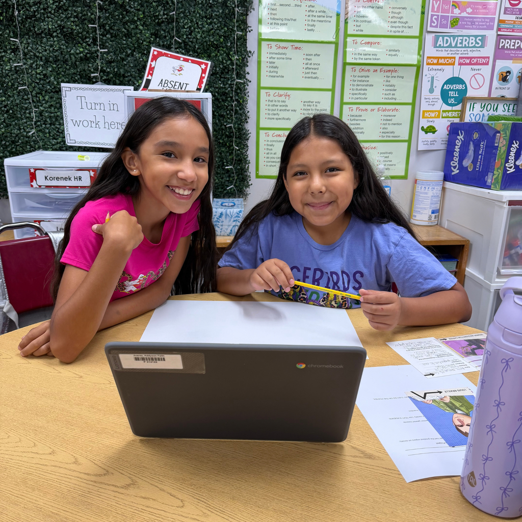 Smiling students working together on a project in the classroom