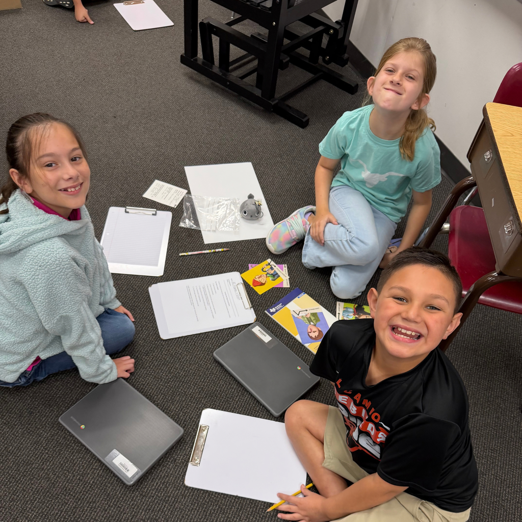Smiling students working together on a project in the classroom