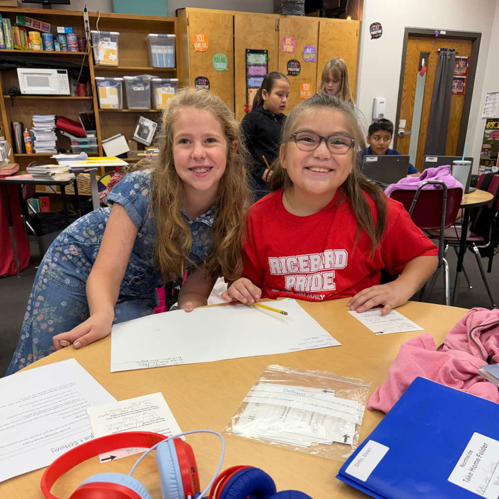 Smiling students working together on a project in the classroom