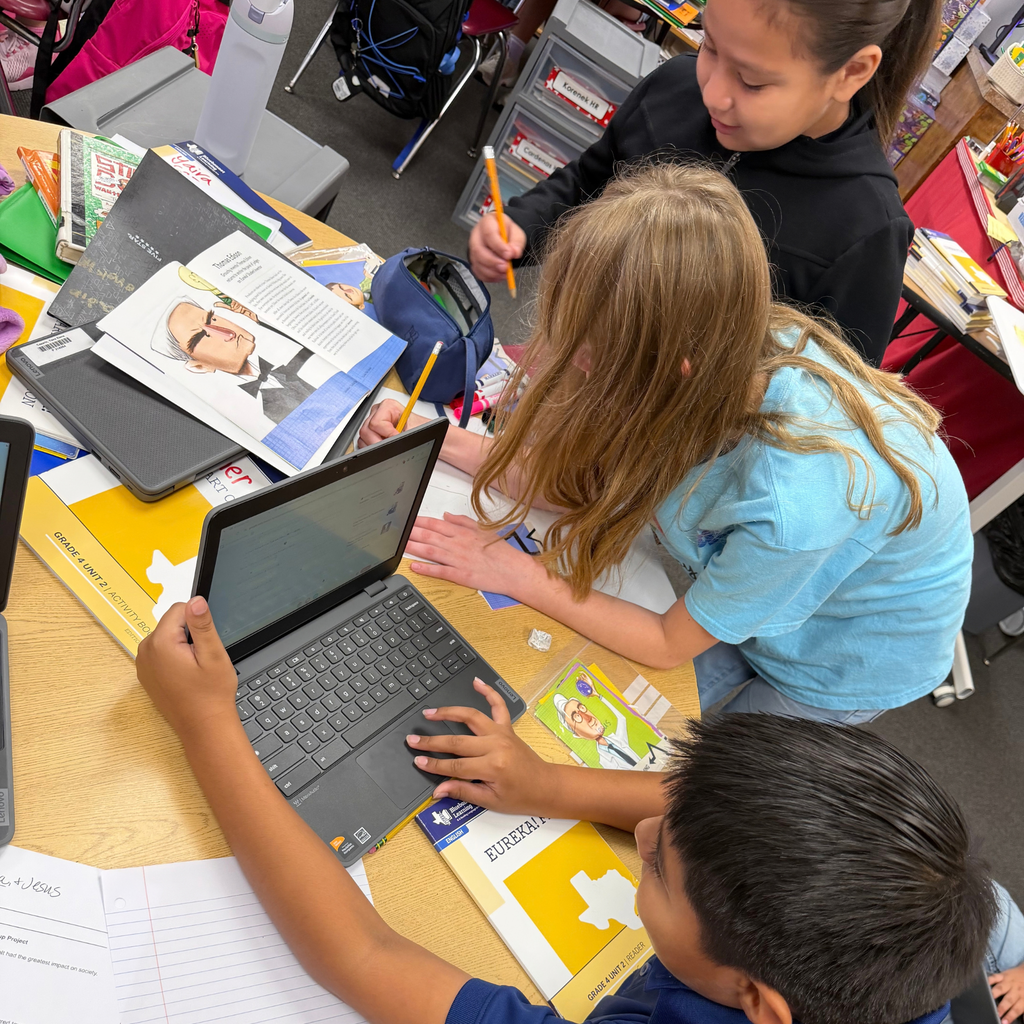 Smiling students working together on a project in the classroom