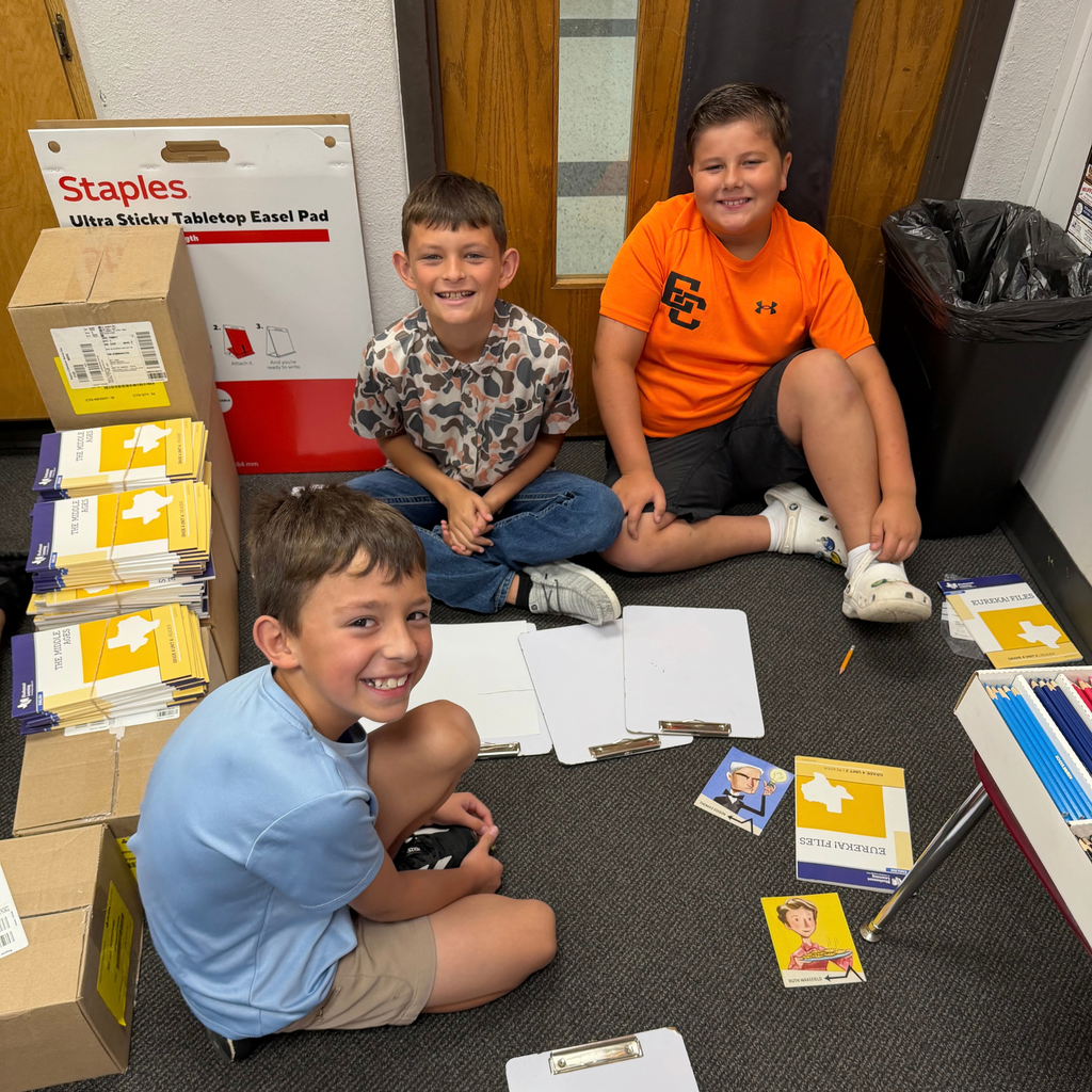Smiling students working together on a project in the classroom