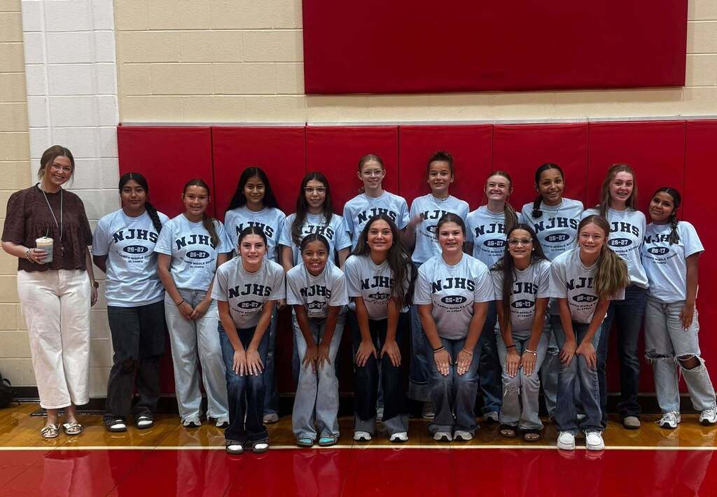 several ladybirds in NJHS shirts posing with a teacher