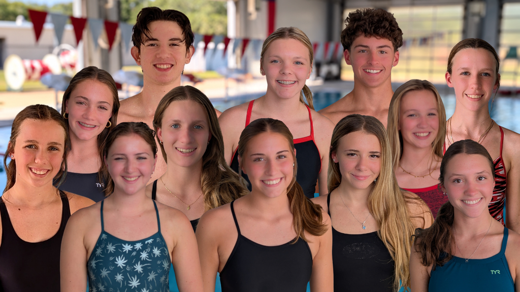 several athletes gathered near the side of the pool