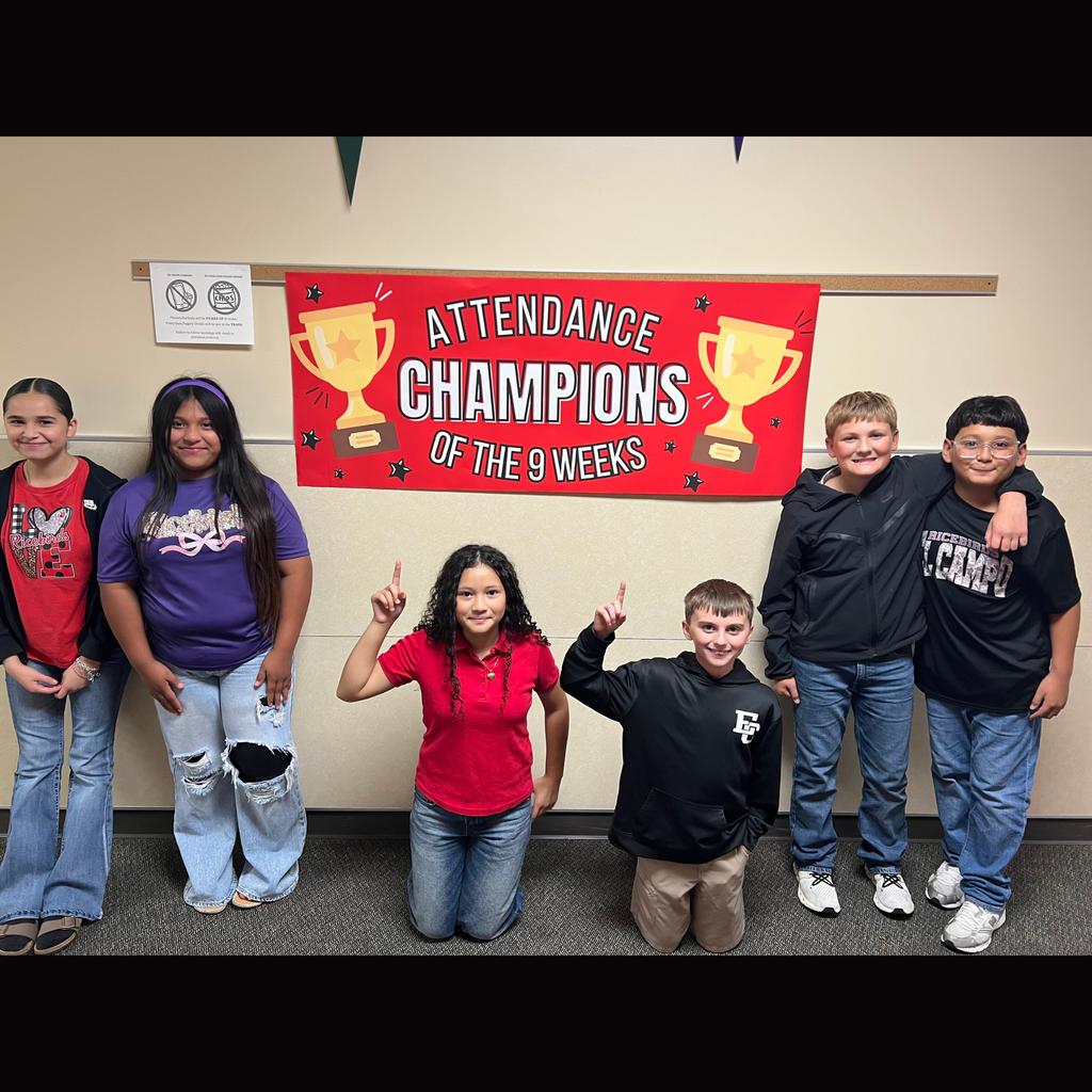 Seven El Campo Middle School 6th grade students posing together in front of a red banner with golden trophies that reads "Attendance Champions of the 9 Weeks."